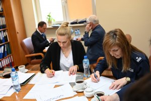 Sędziowie sprawdzają test z wiedzy, napisany przez uczestników Turnieju Motoryzacyjnego.